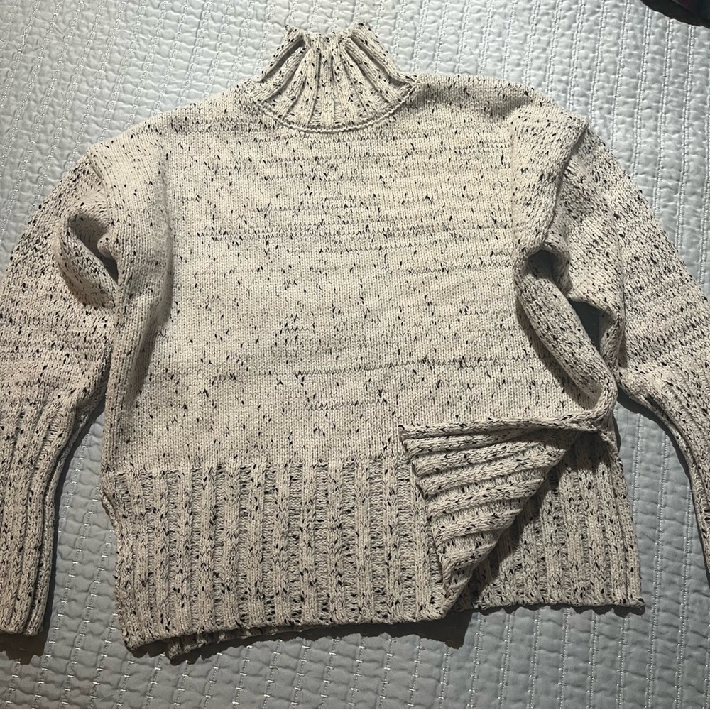 White and black speckled turtleneck sweater